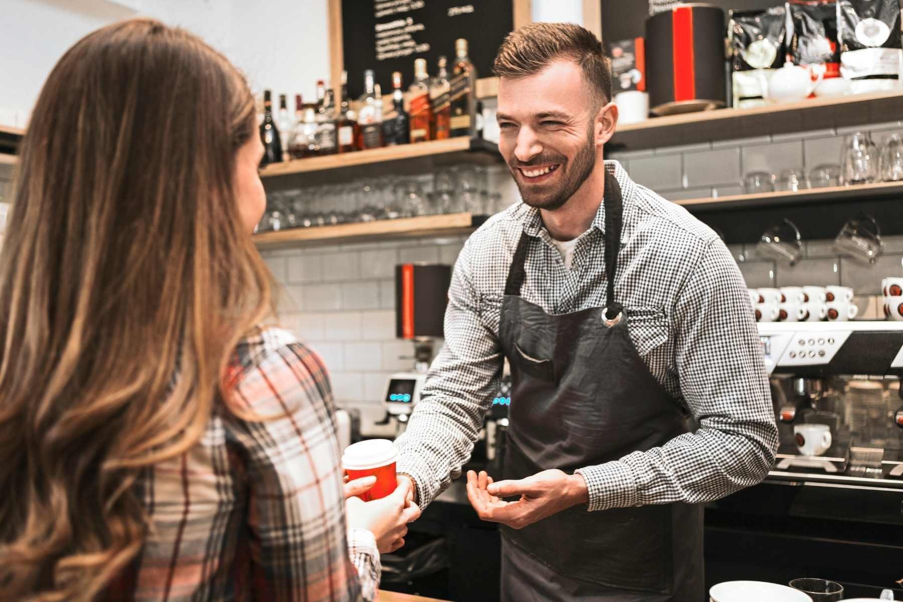 Customer collecting free coffee as a reward for customer loyalty