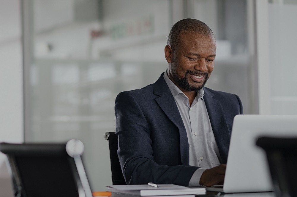 Business owner getting coached on Laptop