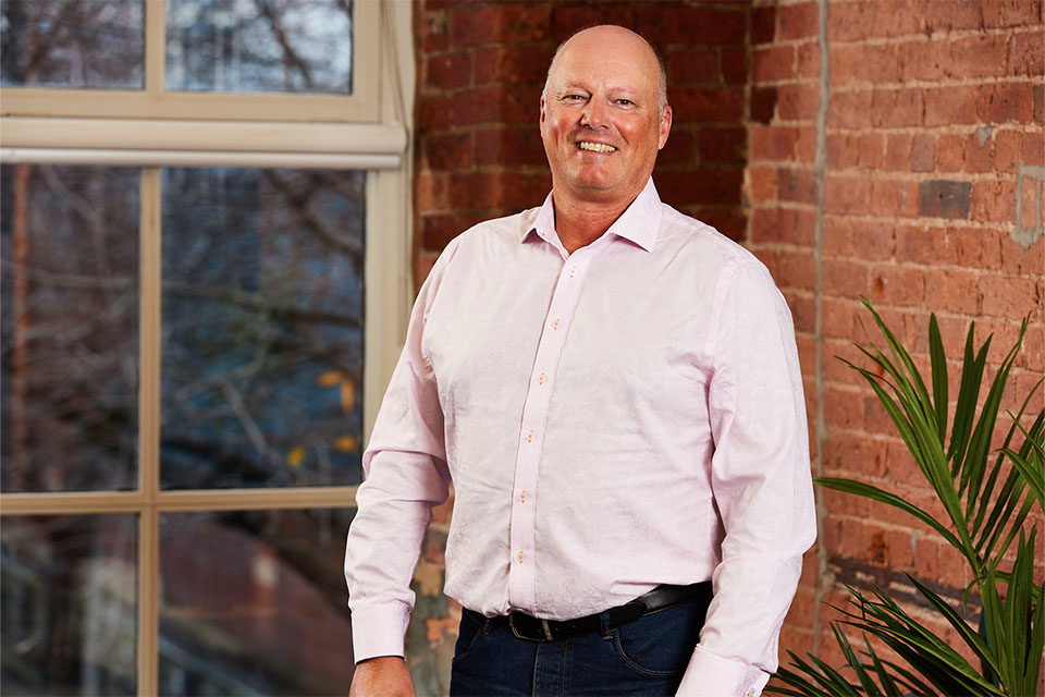 Male business owner smiling after business coaching session in Oxford