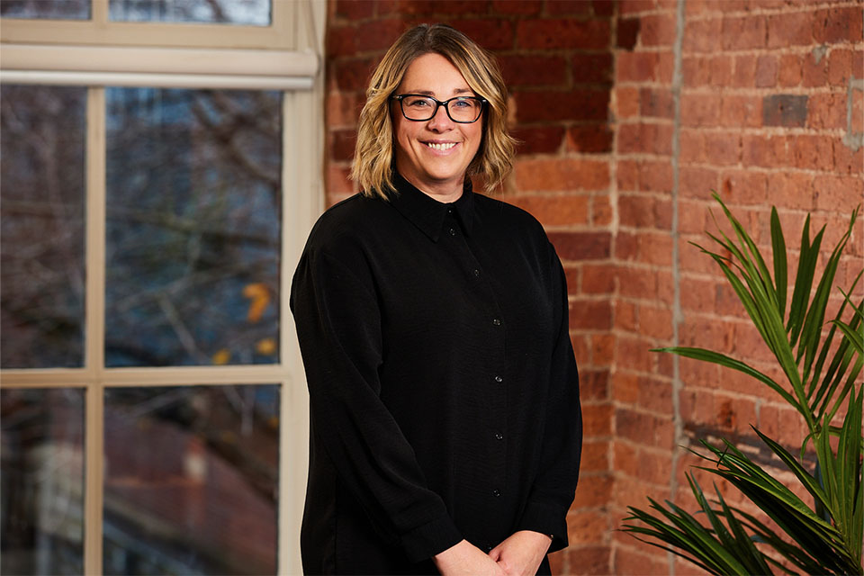 Female business owner smiling after Birmingham business coaching session