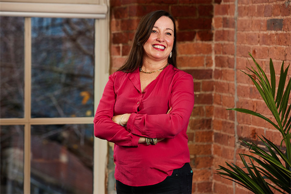 Female business owner smiling after business coaching session in Milton Keynes