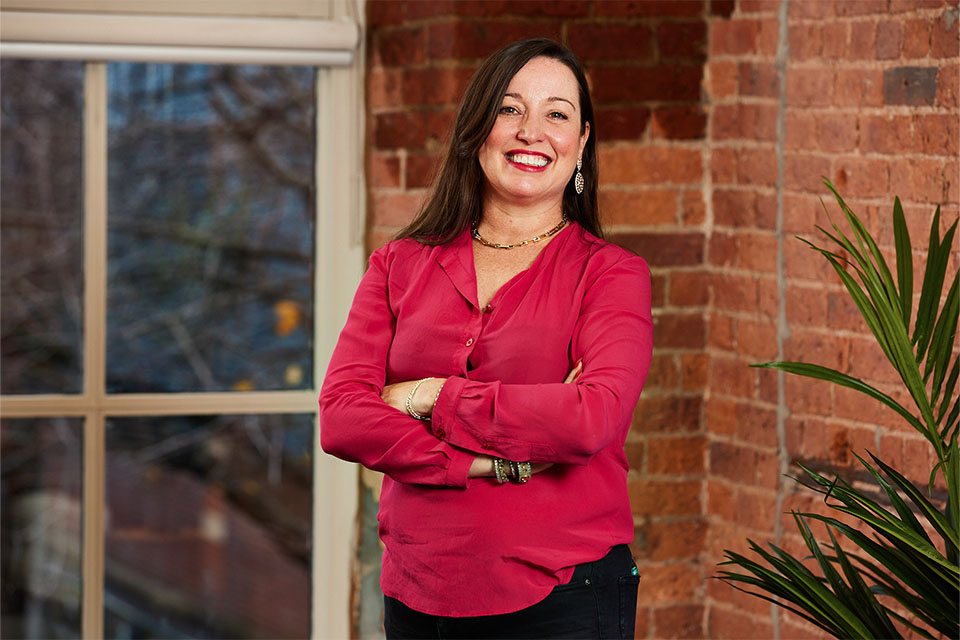 Female business owner smiling after business coaching session in Guildford